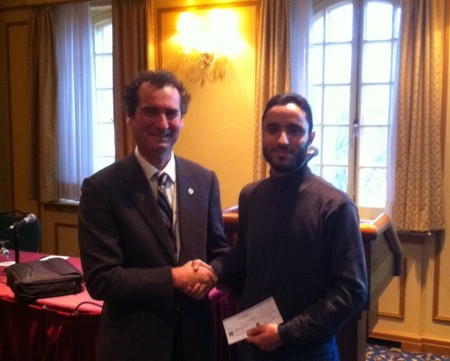 Jean Legault, KEGS, presents GSC Pioneers Scholarship to Majid El Baroudi at Nov 23 KEGS/Québec breakfast.